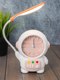 Миниатюра изображения товара Настольные часы ILikeGift Cheerful Cosmonaut со светильником / CD263-01 (розовый)